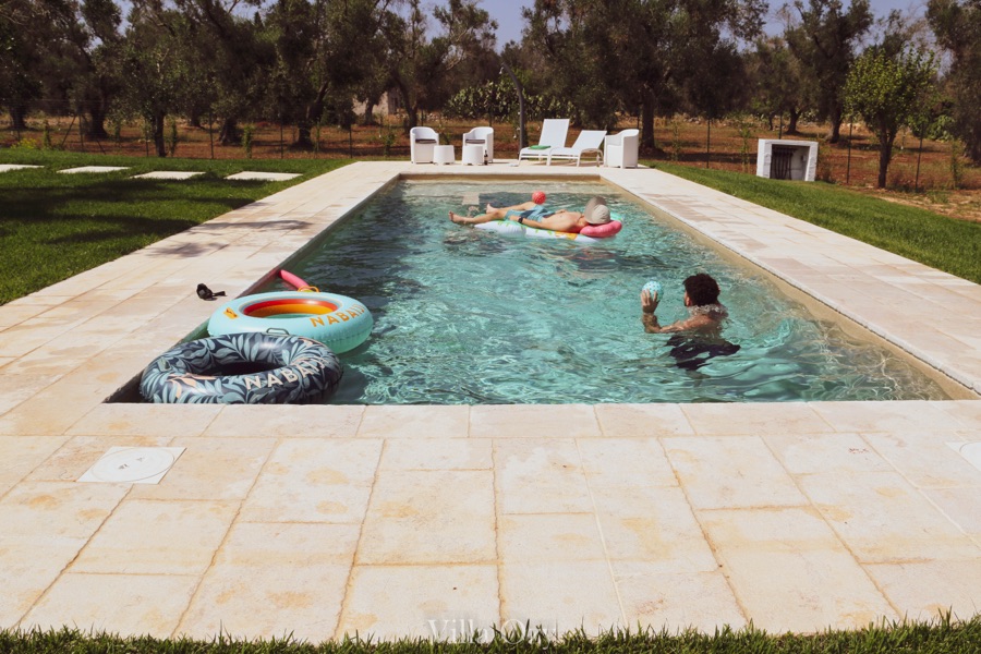 Guests floating in the pool on a hot afternoon